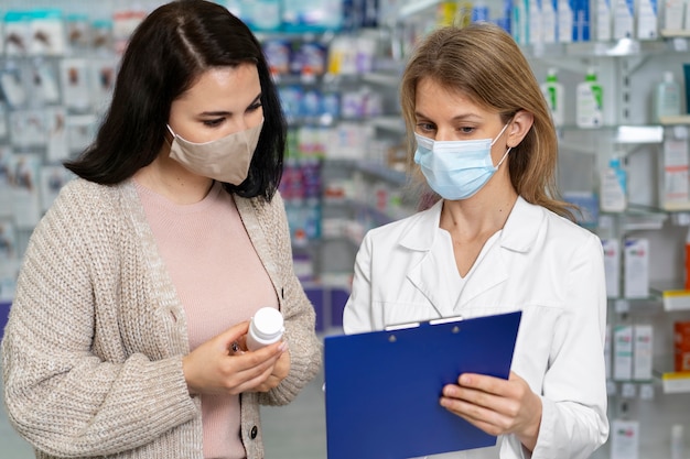 Foto gratuita farmacéutico de tiro medio que ayuda al paciente