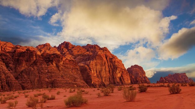 Fascinante vista de los acantilados rocosos arenosos bajo el nublado cielo azul en el desierto