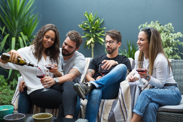 Felices parejas de amigos bebiendo vino