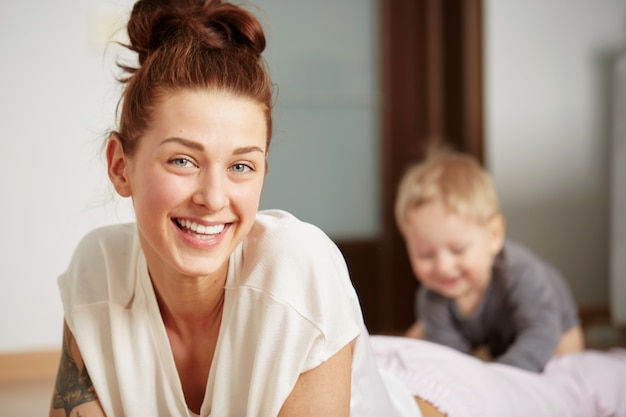 Feliz joven madre con hijo pequeño en casa