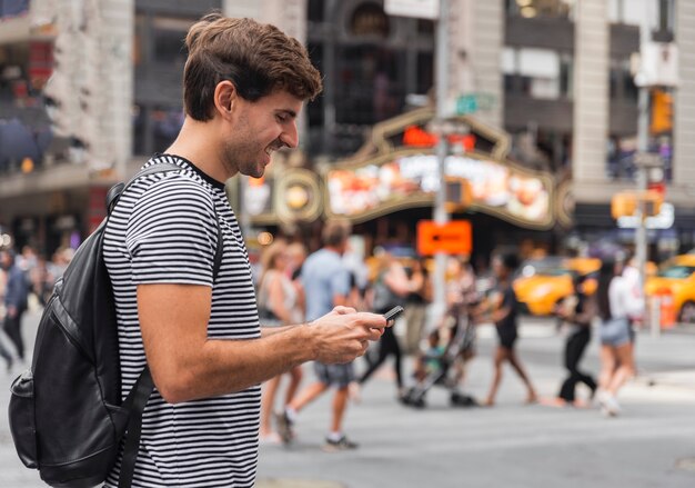 Feliz joven mirando un teléfono inteligente