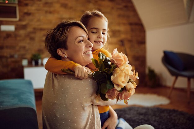 Feliz madre e hija abrazando en casa