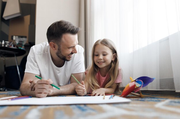 feliz padre sonriente y su hija en casa