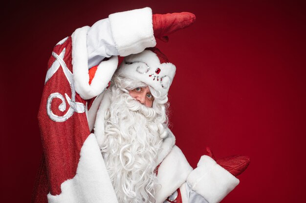 Feliz Papá Noel muestra tamaño o dimensión con las manos en guantes