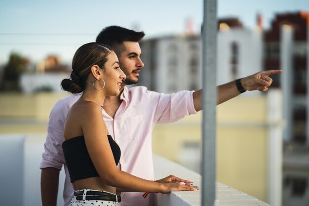 Feliz pareja de pie en el balcón y pasar un rato romántico juntos