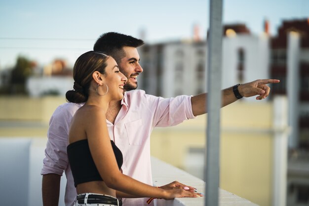 Feliz pareja de pie en el balcón y pasar un rato romántico juntos