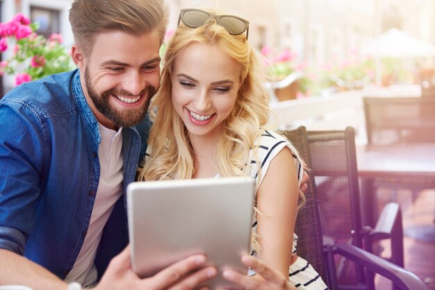 Feliz pareja revisando el menú en la tableta