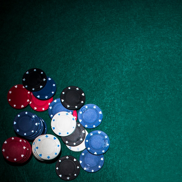 Fichas de casino en la mesa de póquer verde