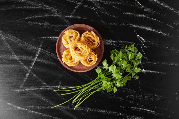 Fideos servidos con manojo de perejil fresco.