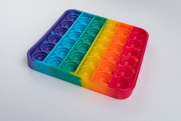 Foto gratuito fidget pop it toy rainbow color - antiestrés, divertido y educativo