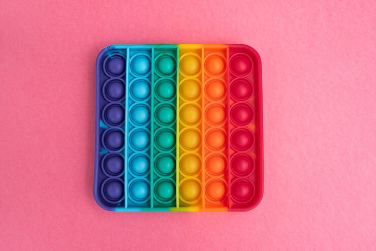 Foto gratuito fidget pop it toy rainbow color - antiestrés, divertido y educativo