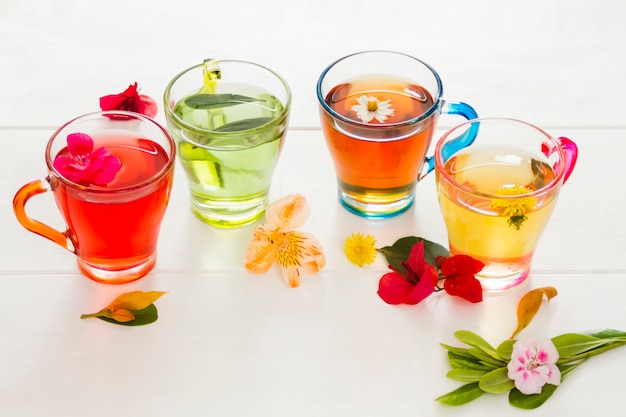 Foto gratuita fila de vasos de té con flores