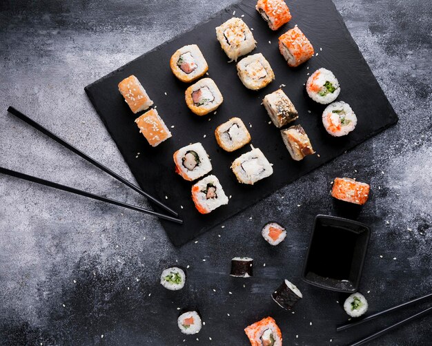 Flat lay delicious sushi and sauce