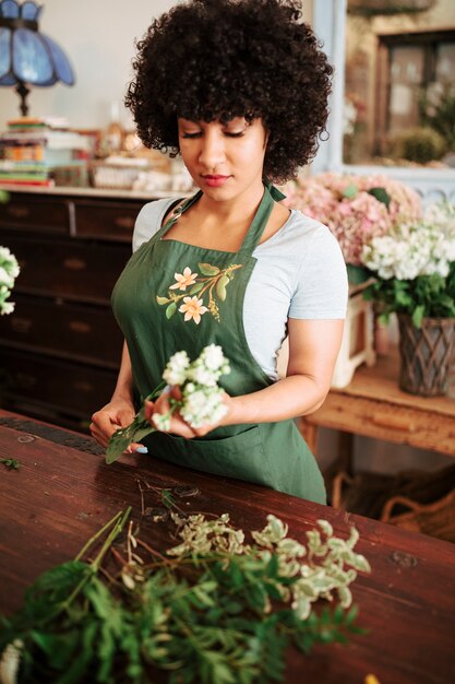 Floreria femenina con ramo de flores blancas en la tienda