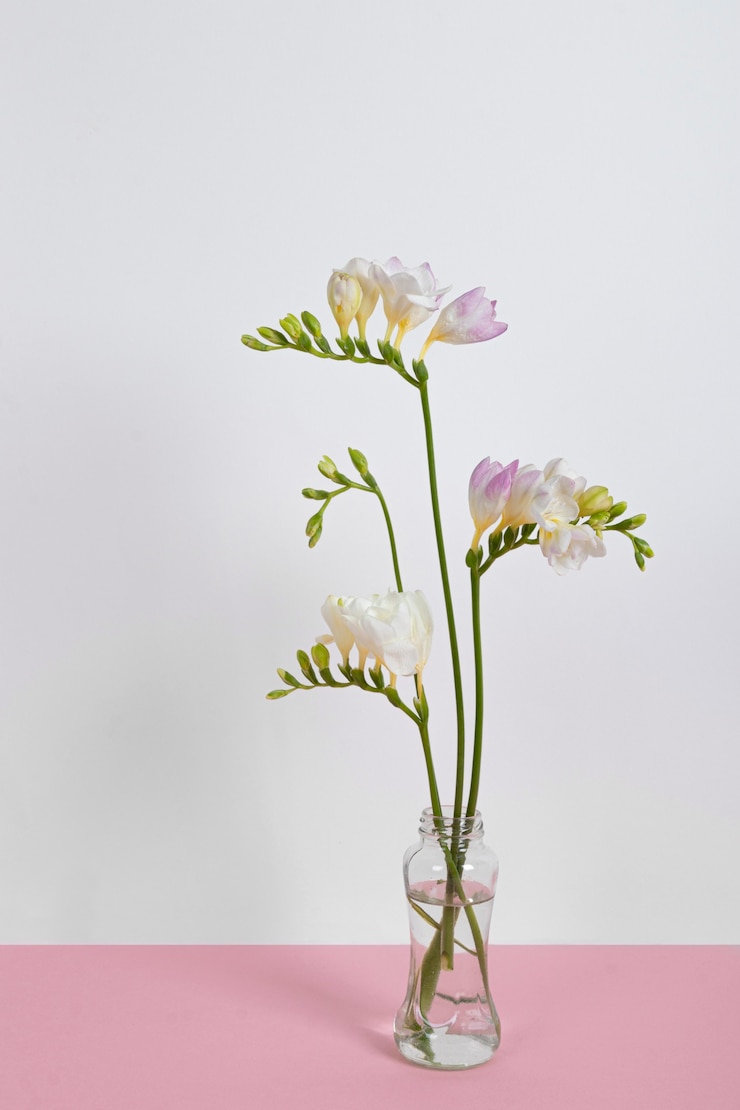 Foto gratuito flores en flor en un jarrón sobre la mesa