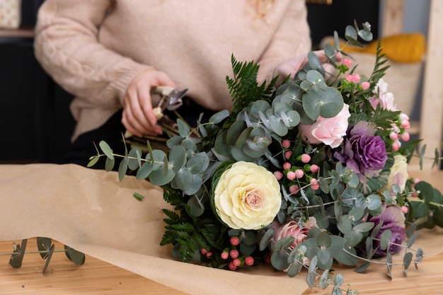 Foto gratuita floristería de cerca haciendo ramo