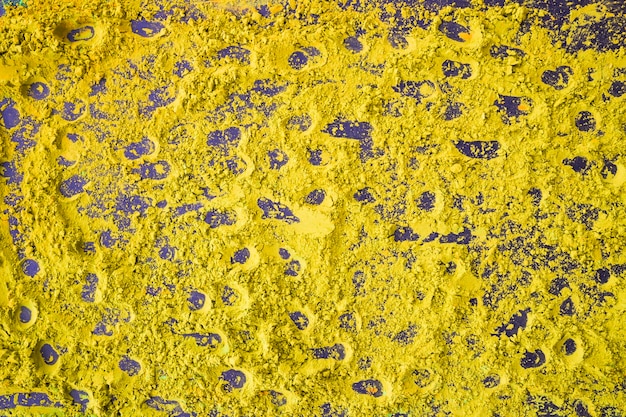 Fondo amarillo abstracto del polvo de holi