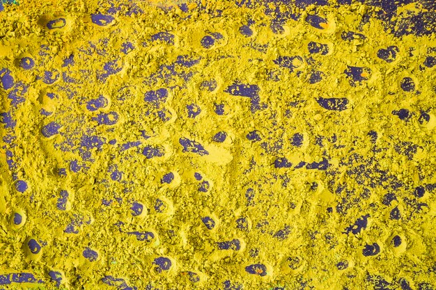 Fondo amarillo abstracto del polvo de holi