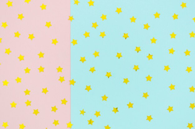 Fondo bicolor con confeti de estrellas amarillas