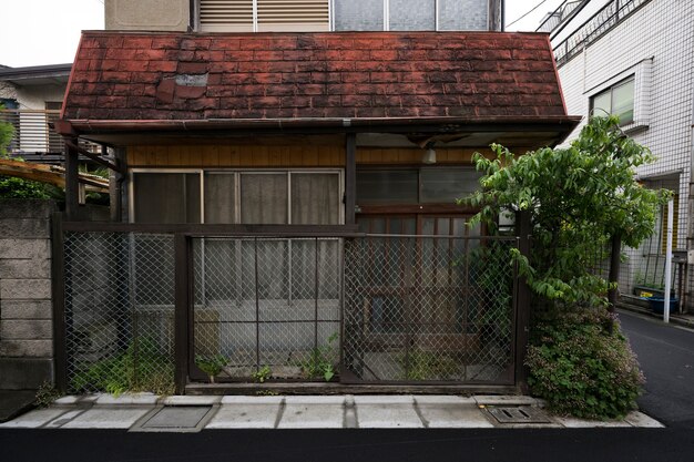 Fondo de casa abandonada con cerca oxidada