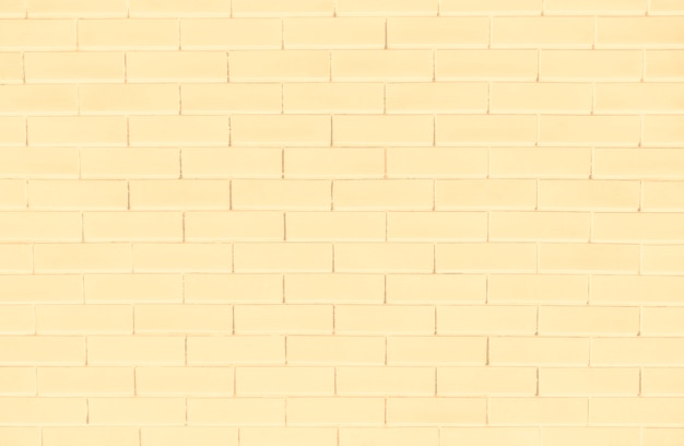 Fondo de pared de ladrillo amarillo con textura