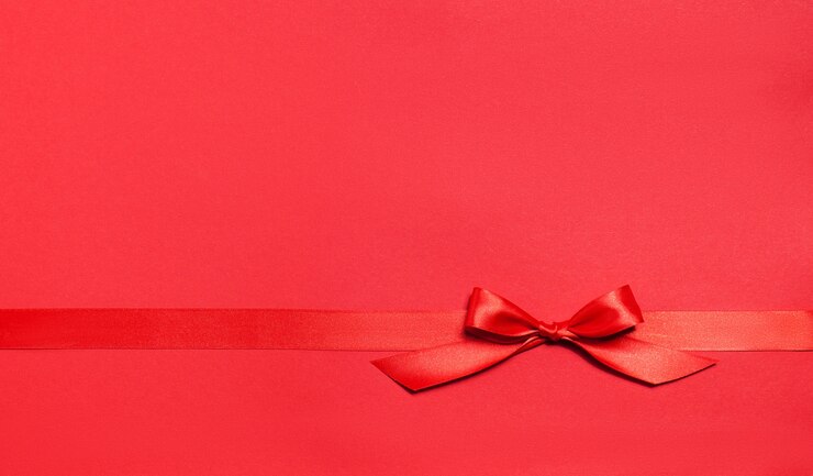 Foto gratuito fondo rojo con un lazo rojo