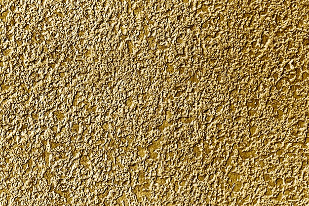 Fondo de superficie de muro de hormigón pintado de oro aproximadamente