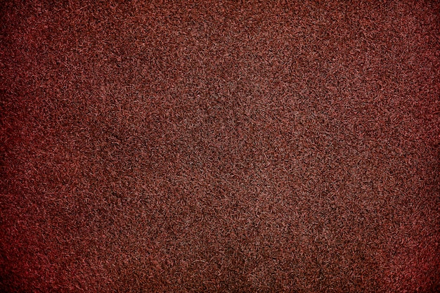 Fondo de textura de césped artificial rojo