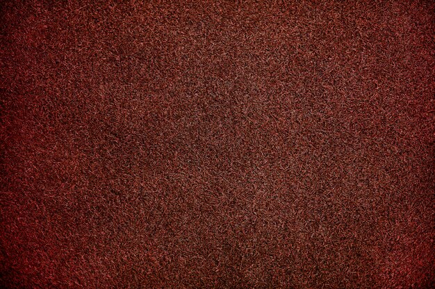 Fondo de textura de césped artificial rojo