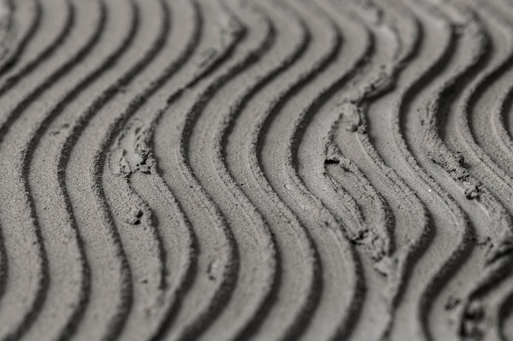 Foto gratuito fondo con textura de hormigón con patrón de onda gris