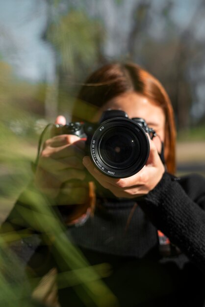 Fotógrafo de tiro medio con cámara