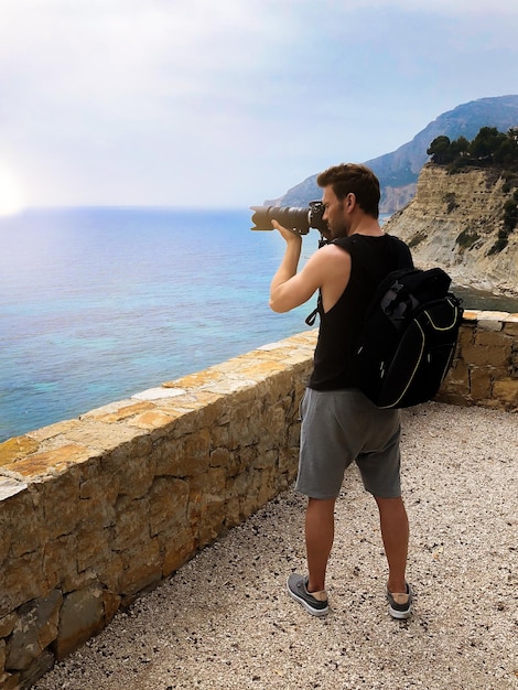 Fotógrafo tomando una foto de una costa oceánica