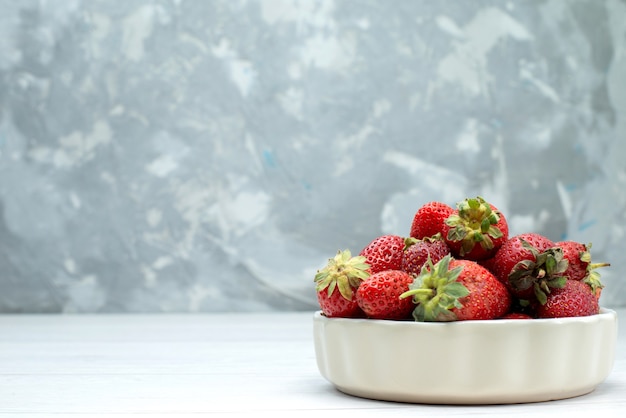 Foto gratuita fresas rojas frescas bayas suaves y deliciosas dentro de un plato blanco a la luz, color rojo fresco de la baya de la fruta