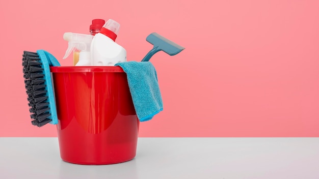 front view of bucket with cleaning solutions and copy space