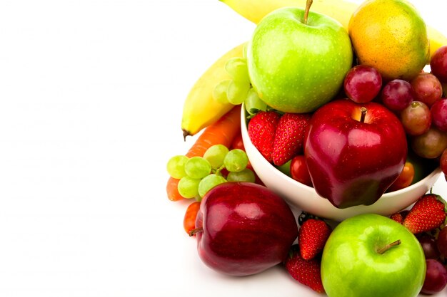 La fruta fresca en un plato aislado en blanco