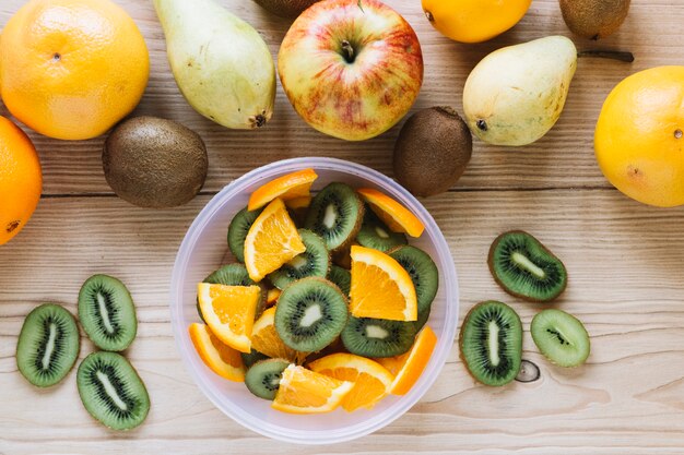 Frutas cerca de un tazón con ensalada