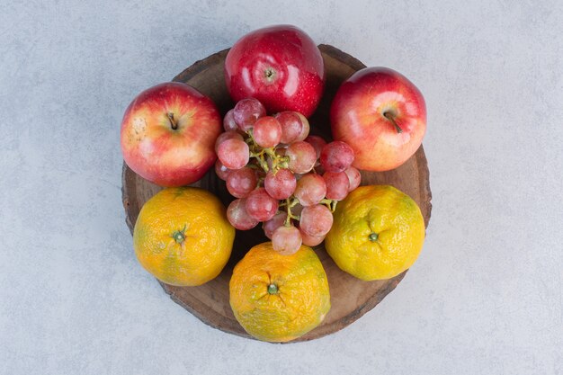 Frutas frescas de temporada. Manzana roja y uva con mandarina.