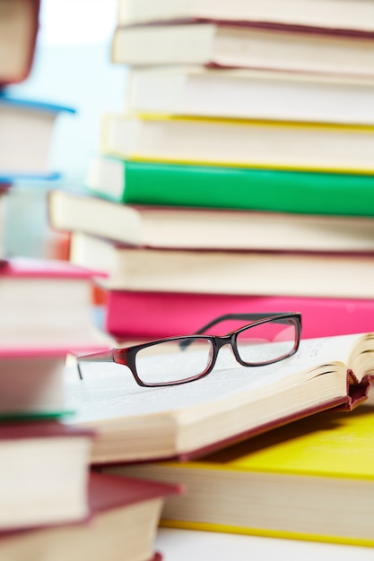 Gafas con una pila de libros