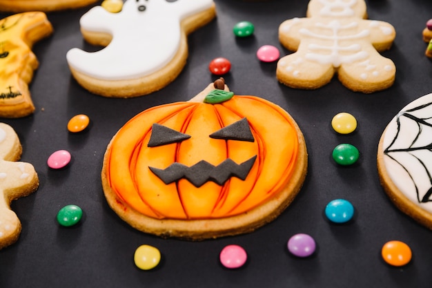 Foto gratuita galleta de jack-o-linterna entre las golosinas