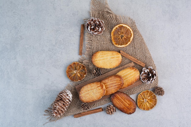 Galletas caseras sobre arpillera con piñas y frutos secos. Foto de alta calidad