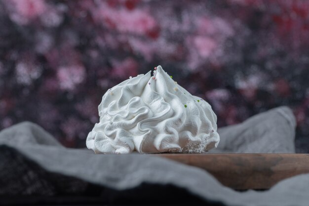 Galletas de merengue floral blanco sobre la mesa.