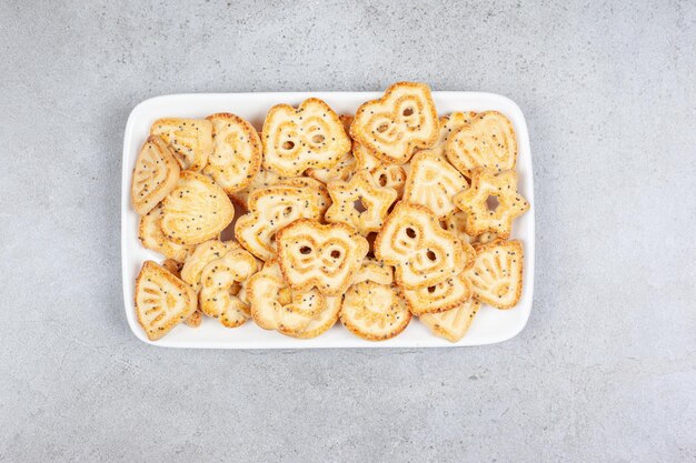 Galletas en un plato blanco sobre fondo de mármol. Foto de alta calidad