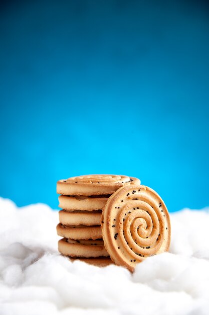 Galletas de vista frontal apiladas una encima de la otra sobre fondo azul.