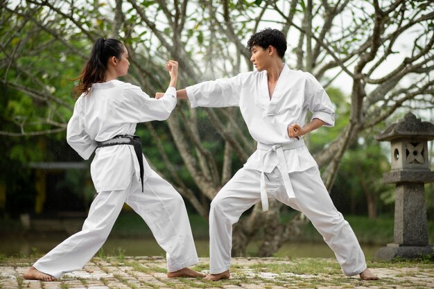 Gente al aire libre en la naturaleza entrenando para taekwondo