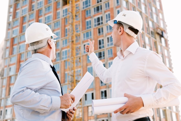 Gente de ángulo bajo mirando andamios de construcción