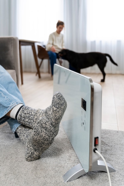 Gente en casa con lindo perro y calentador.