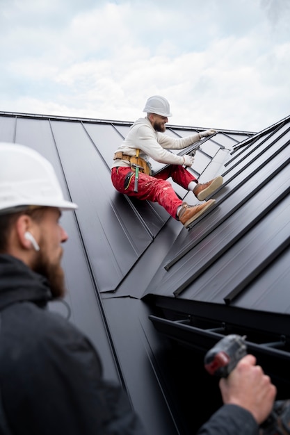 Gente de la construcción trabajando en el techo