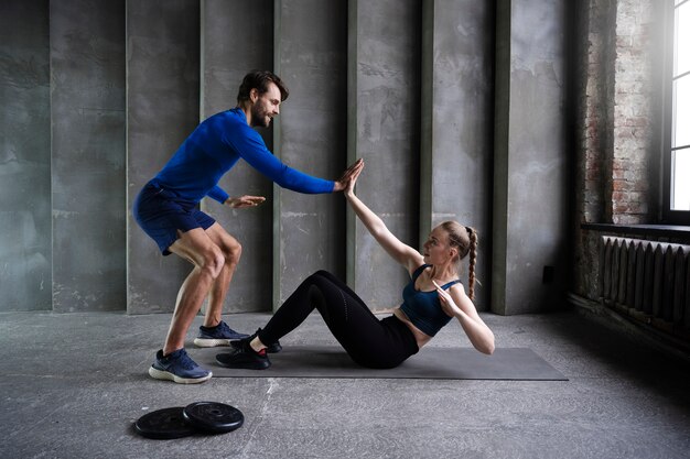 Gente deportiva de tiro completo haciendo ejercicio dentro