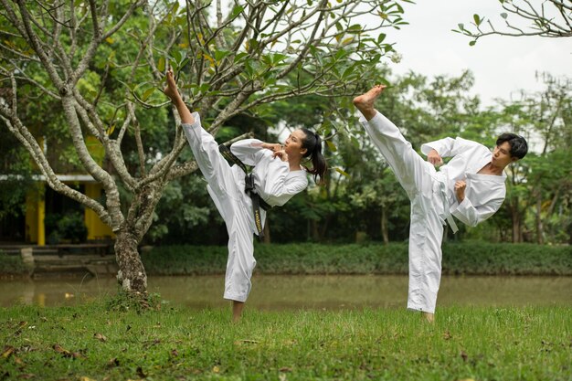 Gente entrenando juntos al aire libre para taekwondo