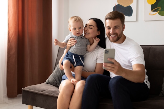 Foto gratuita gente guapa teniendo una videollamada con su familia en casa